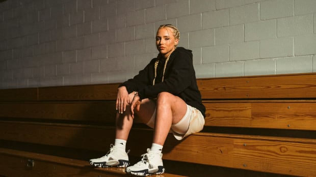 Hailey Van Lith models white and black adidas apparel and basketball shoes.